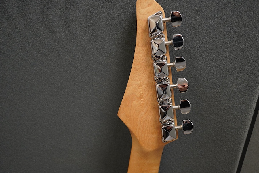A Yamaha ERG121 electric guitar in black finish, with a soft gig case